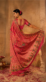 Vibrant Rani pink Silk saree with figurative motifs
